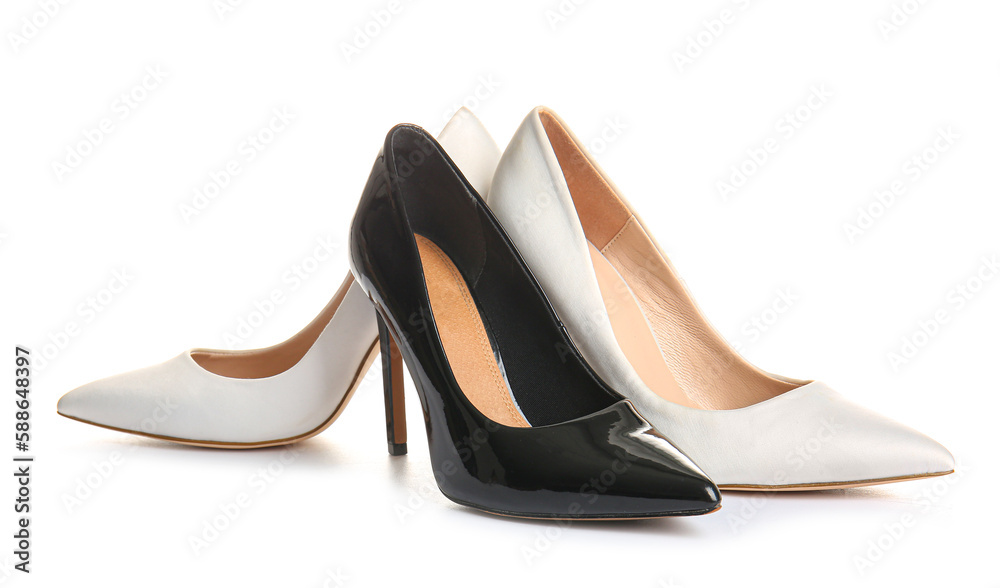 Stylish high heeled shoes on white background