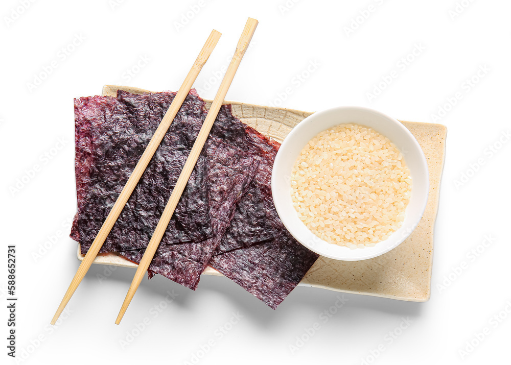 Plate with natural nori sheets, chopsticks and bowl of rice isolated on white background