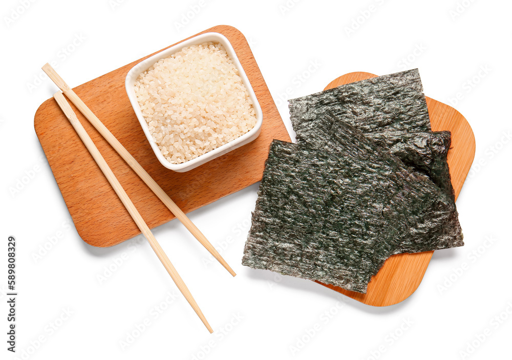 Wooden boards with natural nori sheets and bowl of rice isolated on white background