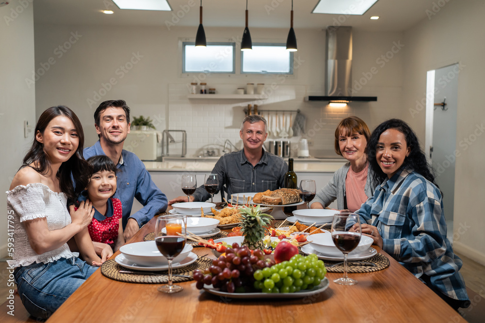 Portrait of Multi-ethnic family having evening dinner party in house. 
