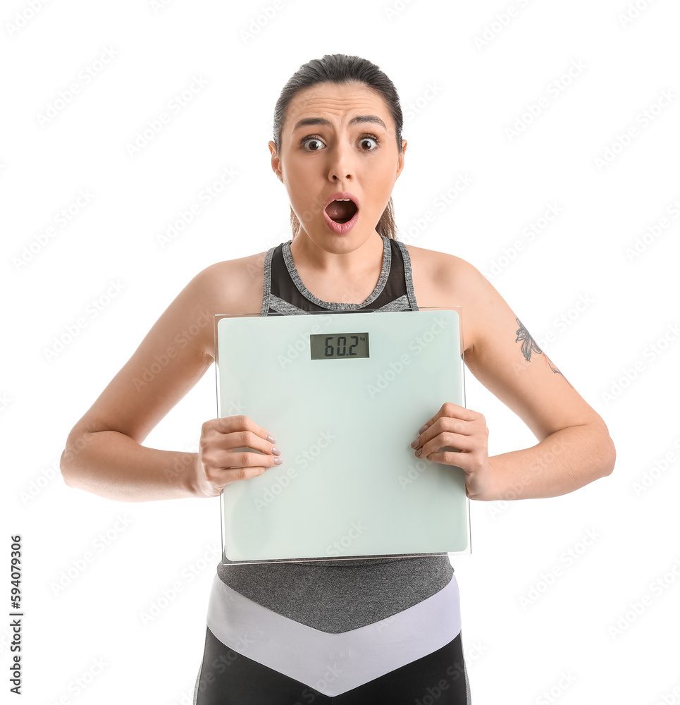 Shocked young woman with scales on white background