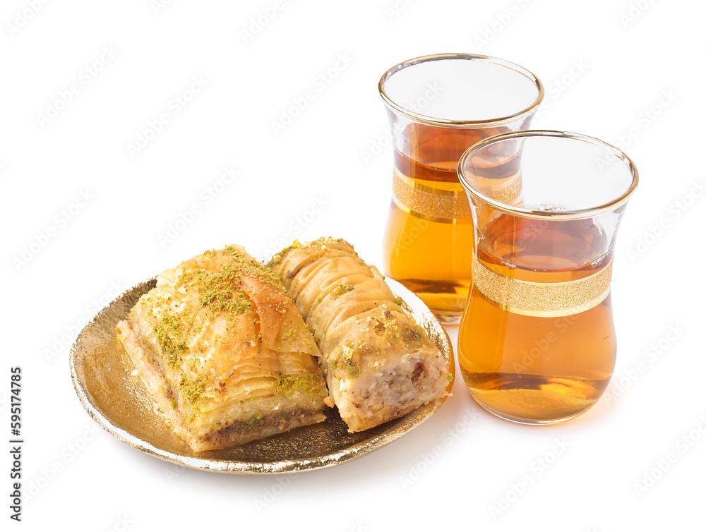 Plate with tasty baklava and glasses of Turkish tea on white background