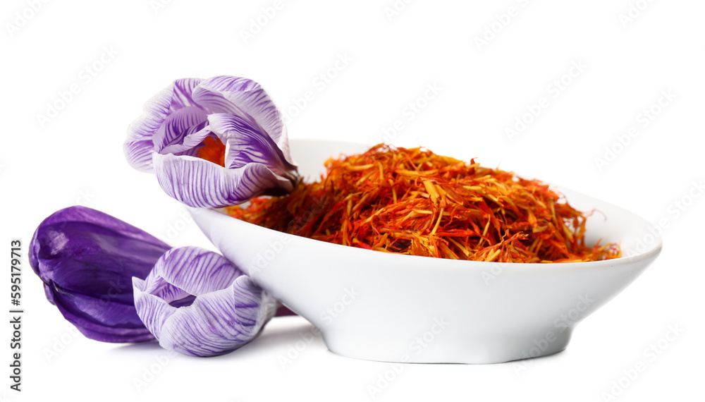 Bowl of dried saffron threads and crocus flowers isolated on white background