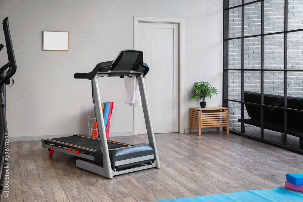 Interior of gym with modern treadmill and sport equipment