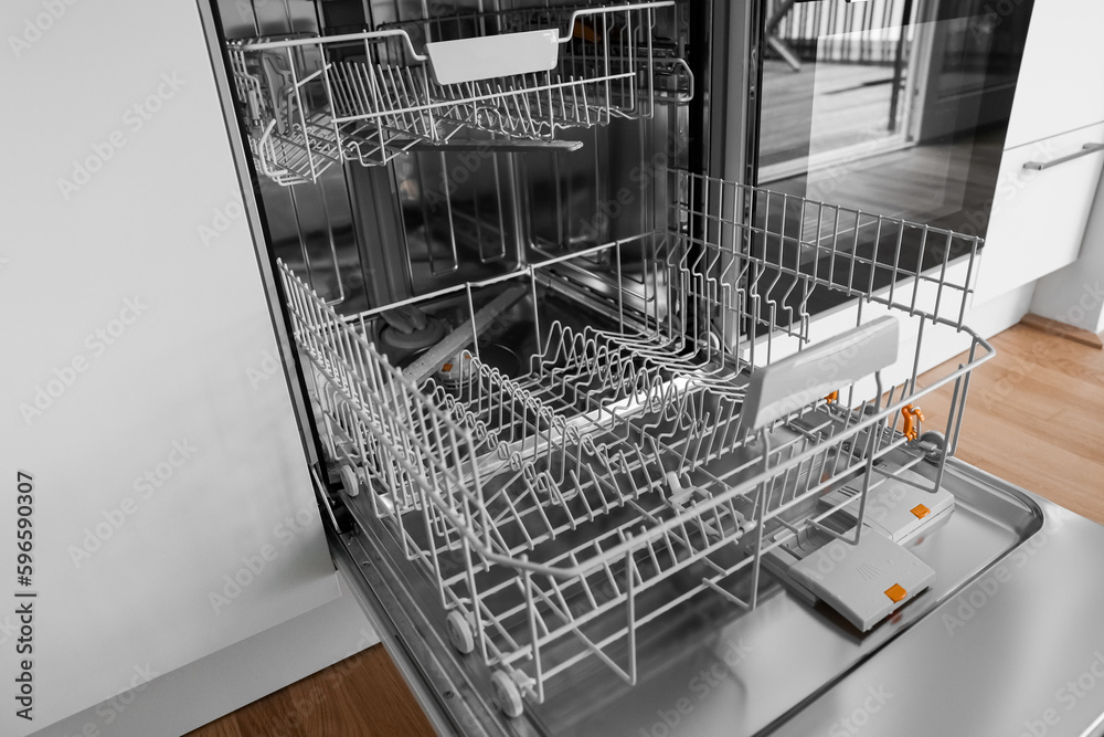 Open dishwasher in modern kitchen, closeup