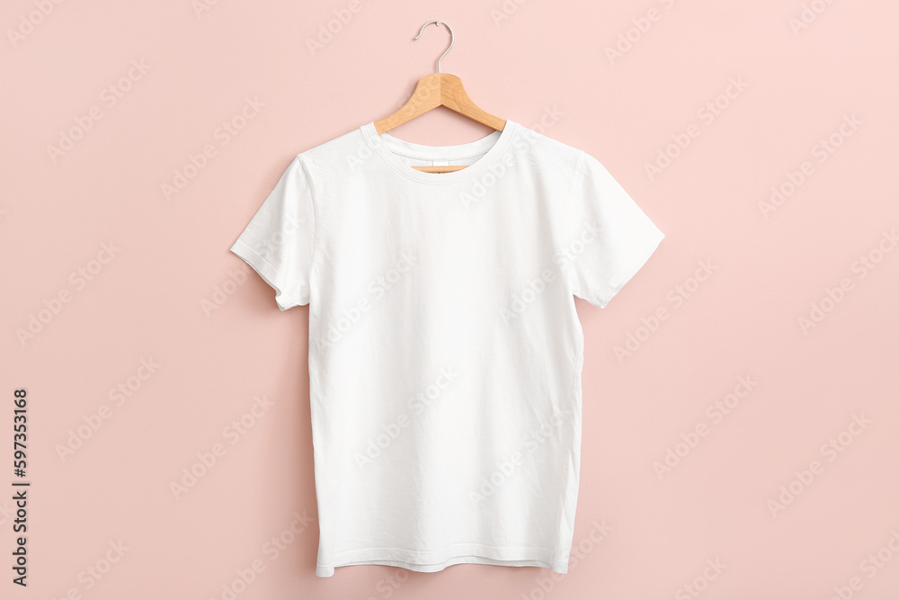 White t-shirt hanging on pink wall