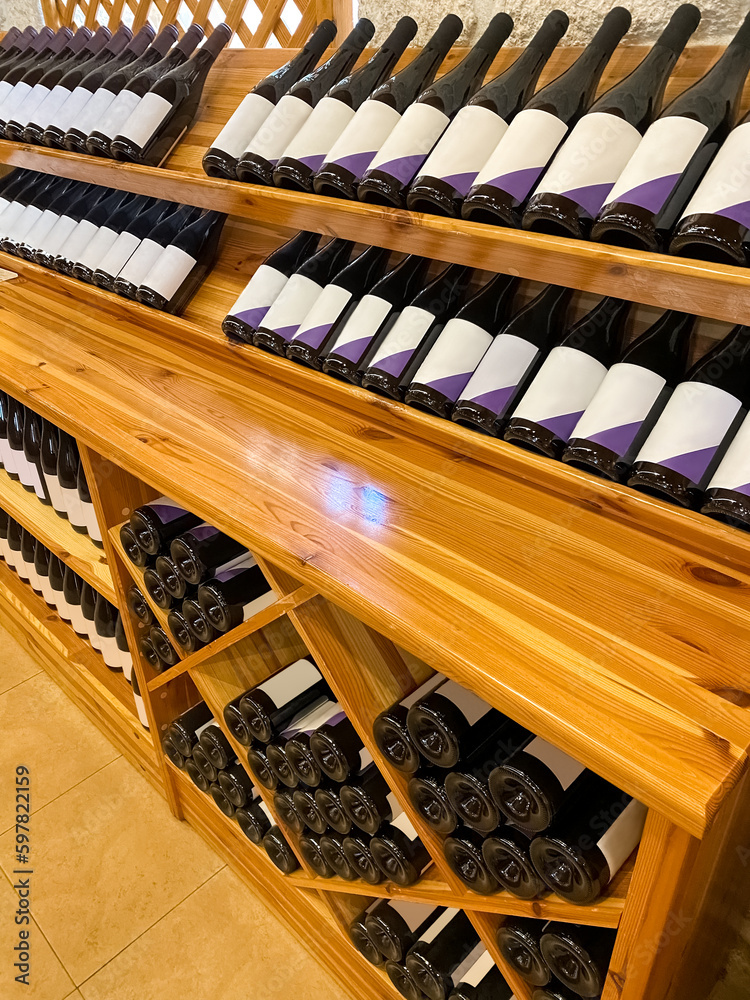 Wooden storage stand with bottles of wine in store