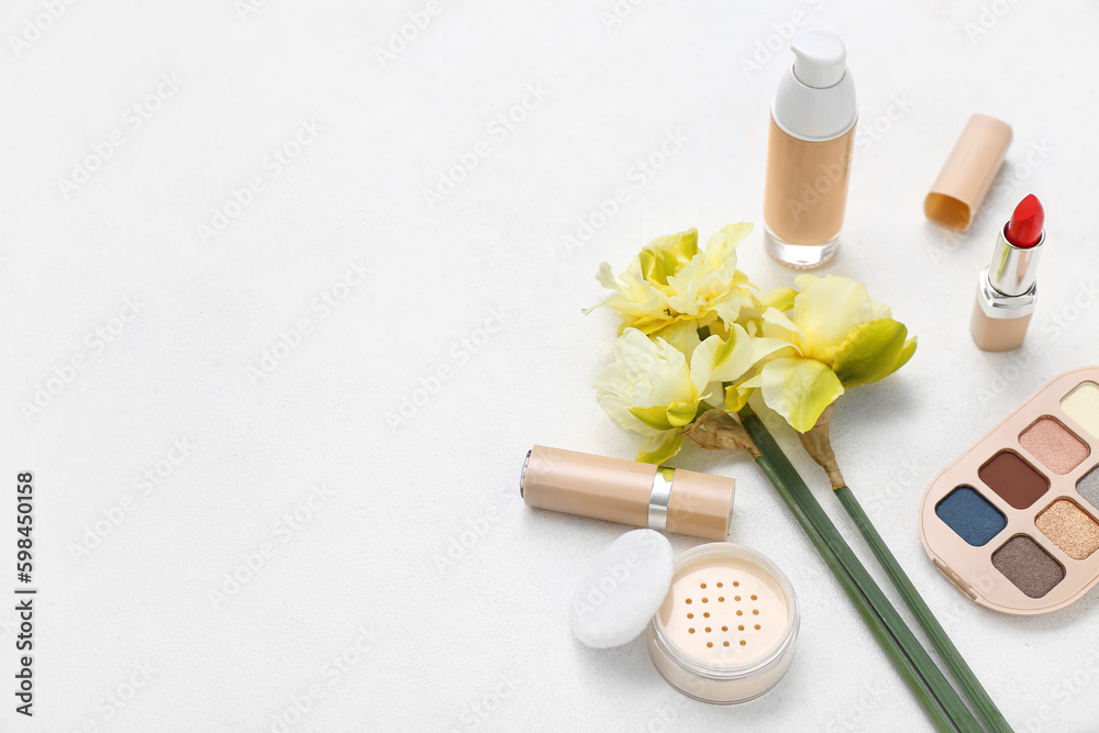Beautiful daffodils with different cosmetics on white background
