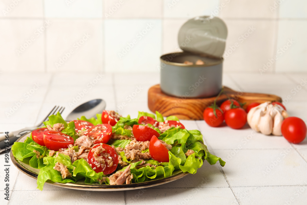 Plate with delicious tuna salad on white tiled table