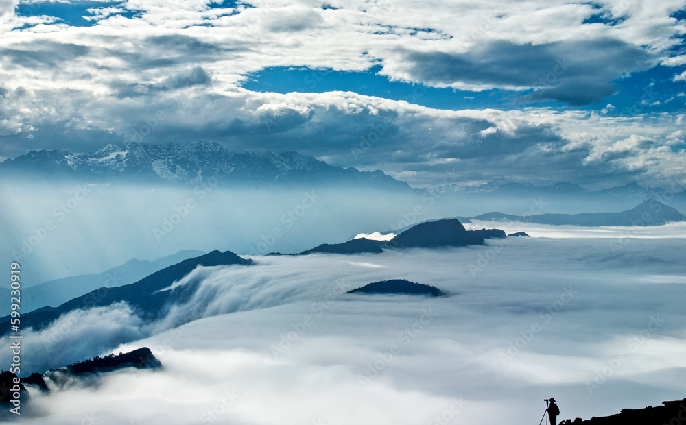 High mountains covered by clouds, sea of clouds, mountain tops, thick clouds