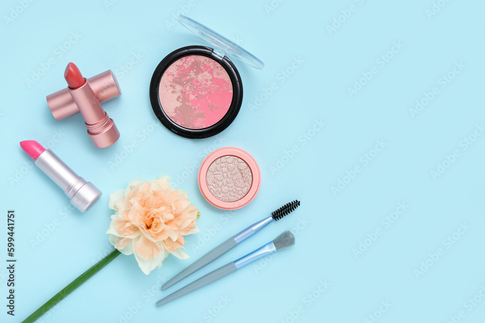 Beautiful daffodil with different cosmetics on blue background