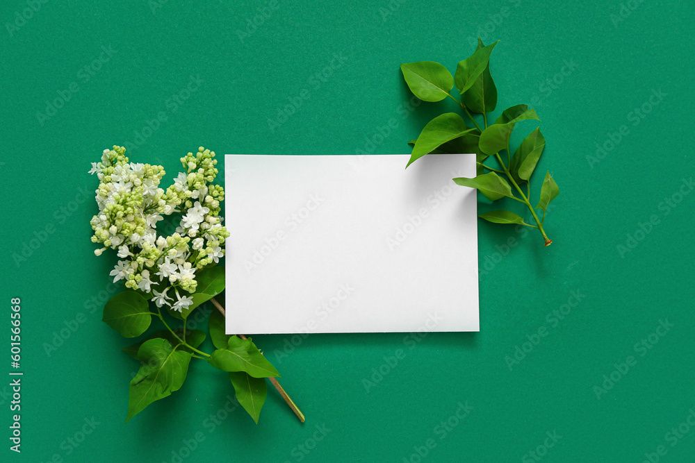 Blank card with lilac flowers on dark green background