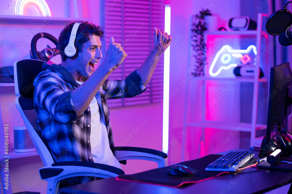 Caucasian e-sport man gamer playing an online video game on computer. 