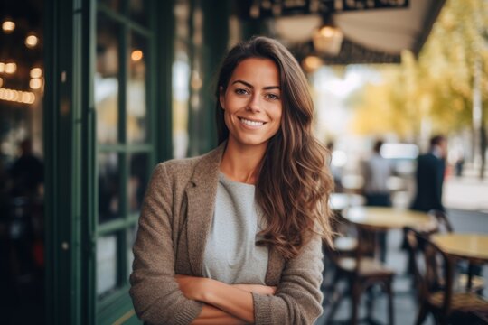 Medium shot portrait photography of a pleased woman in her 30s that is wearing a chic cardigan against a parisian or european cafe background . Generative AI