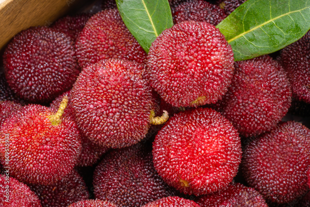 Arbutus berries Fruit or Red Yangmei in basket, Red Bayberry, Yumberry, yamamomo, Waxberry in basket