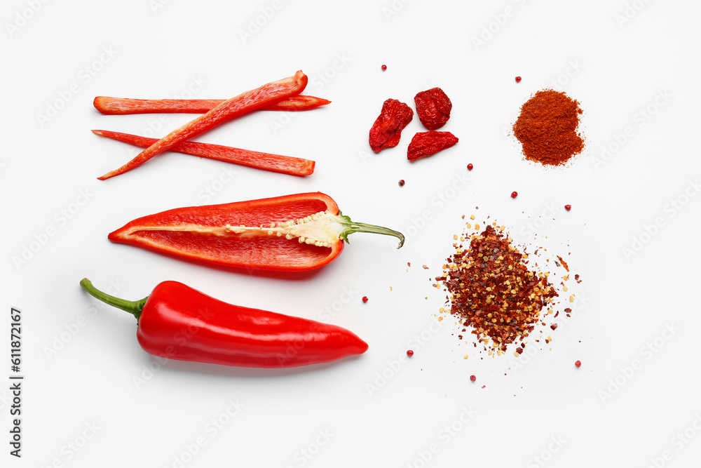 Composition with fresh chili peppers, powder and flakes on light background
