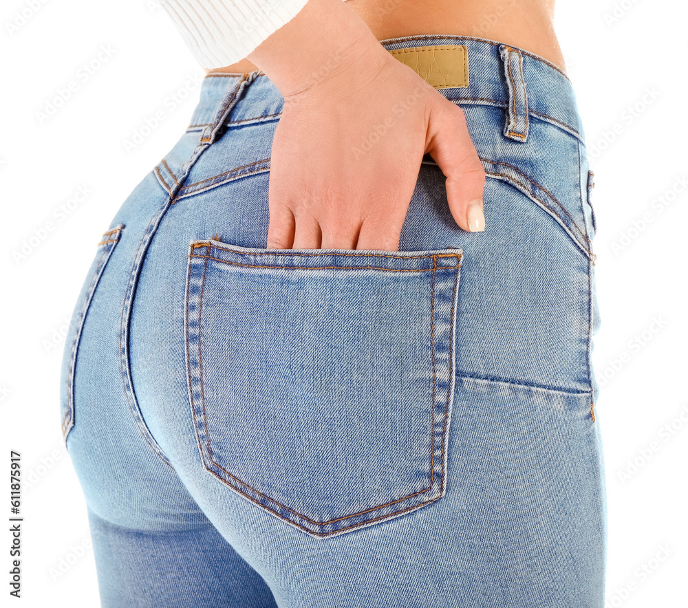 Young woman in skinny jeans on white background, closeup
