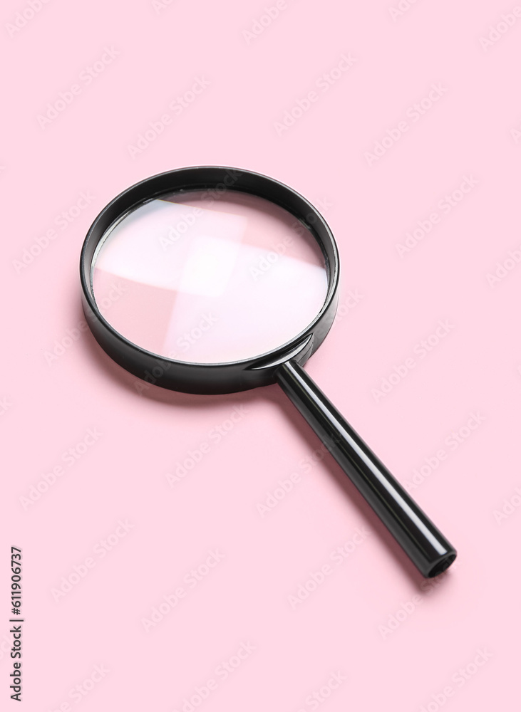 Black magnifier on pink background