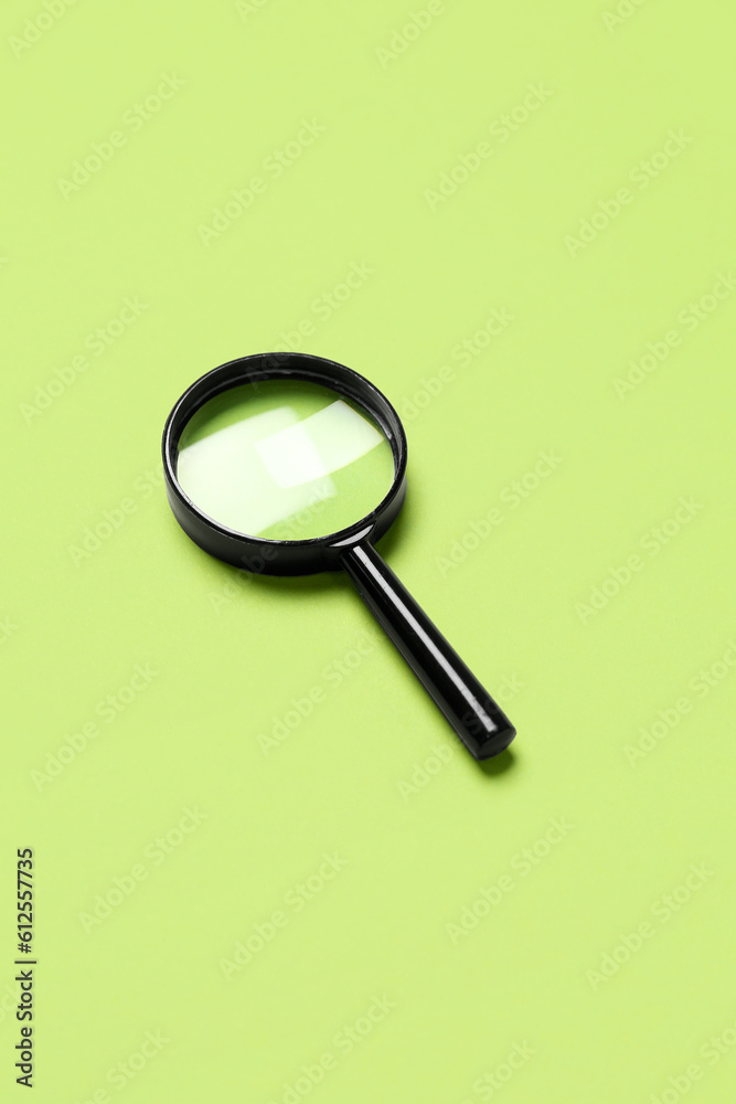 Black mini magnifier on green background
