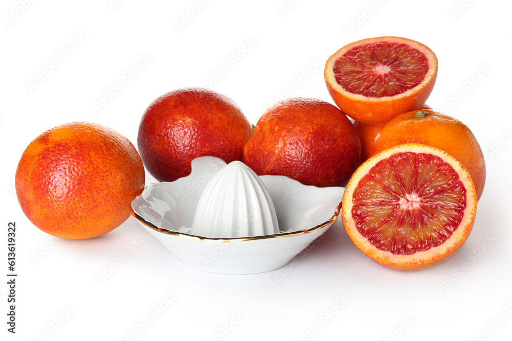 Ceramic juicer and grapefruits on white background