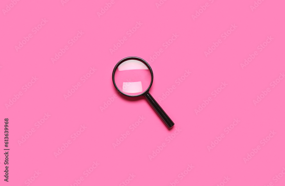 Black mini magnifier on pink background