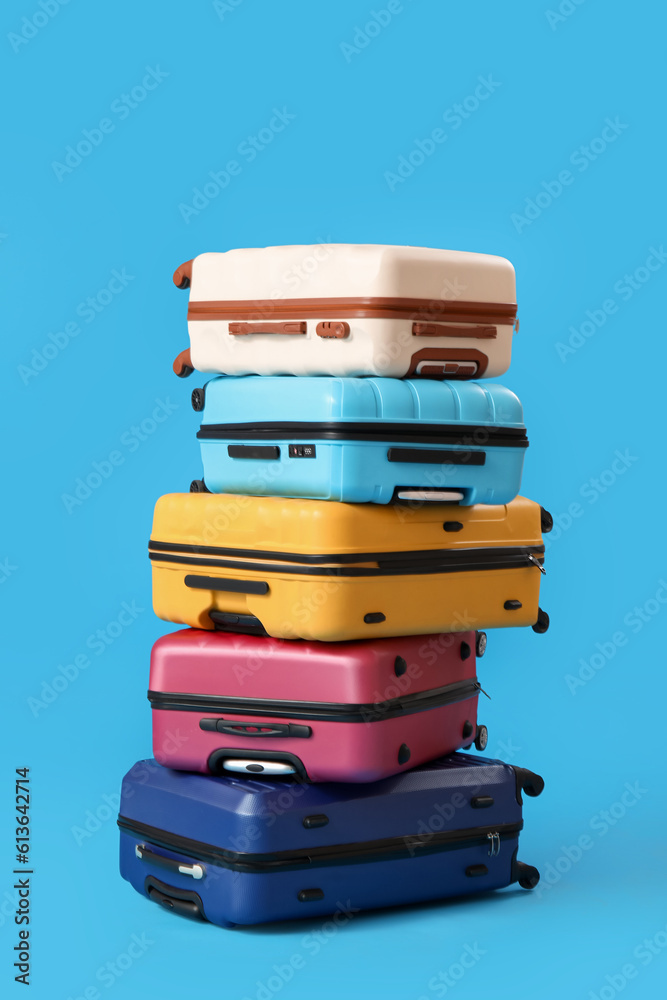Stack of suitcases on blue background