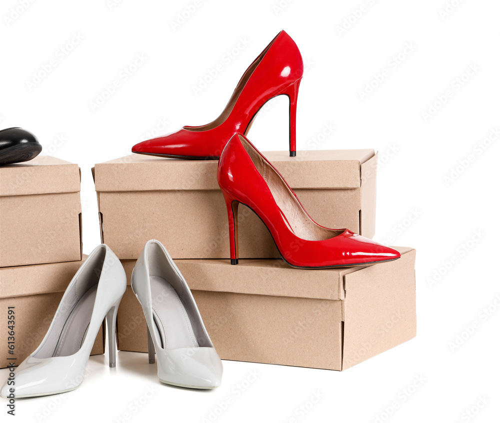 Cardboard boxes with high-heeled shoes on white background