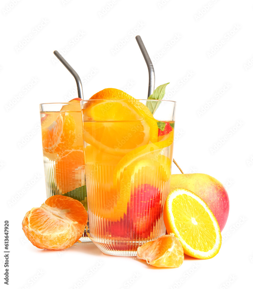 Glasses of infused water with different sliced fruits on white background