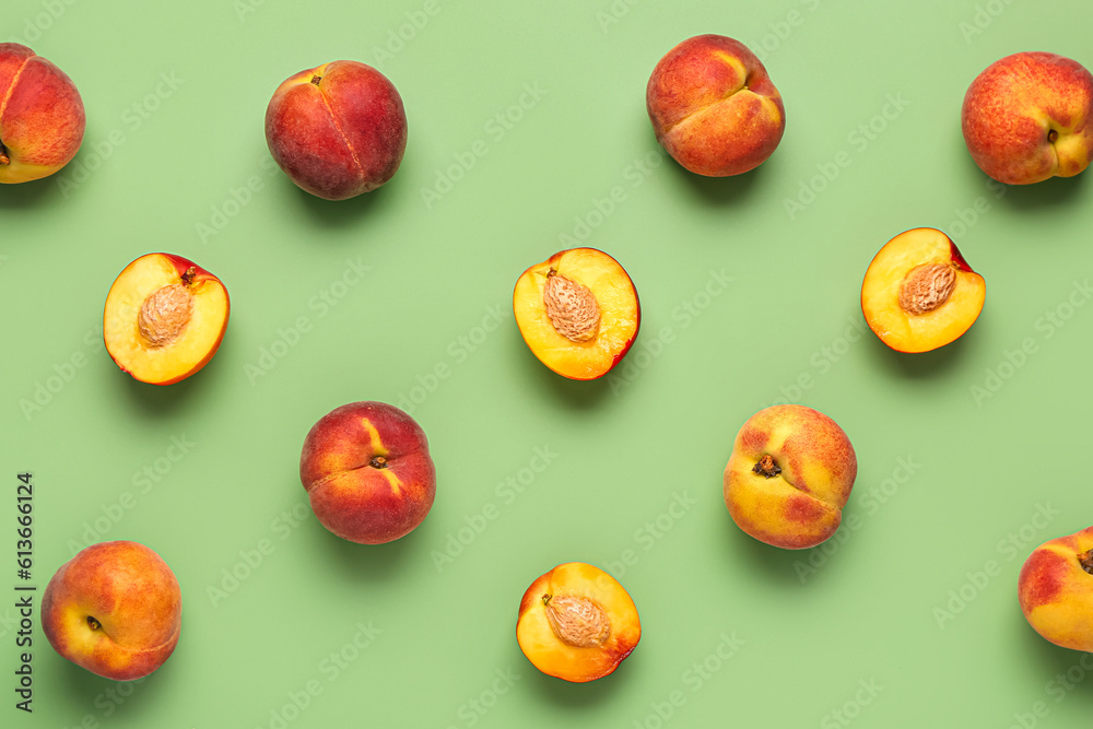 Many sweet peaches on green background