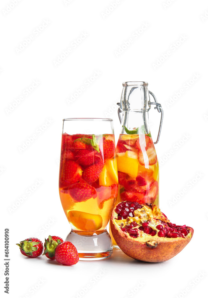 Glass and bottle of infused water with different sliced fruits on white background