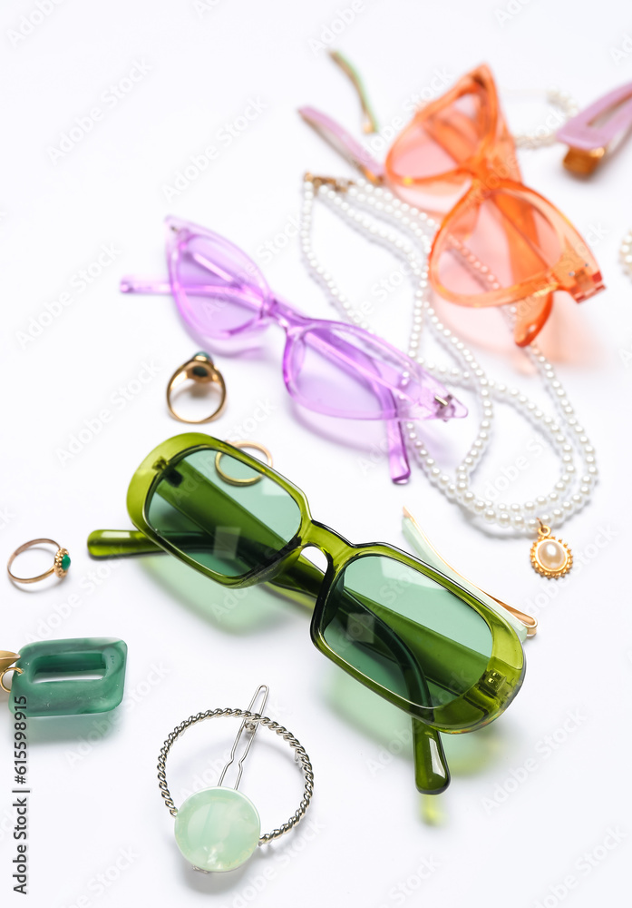 Jewelry with sunglasses on white background, closeup