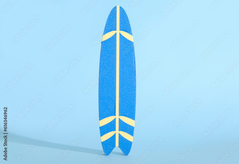 Mini surfboard on blue background
