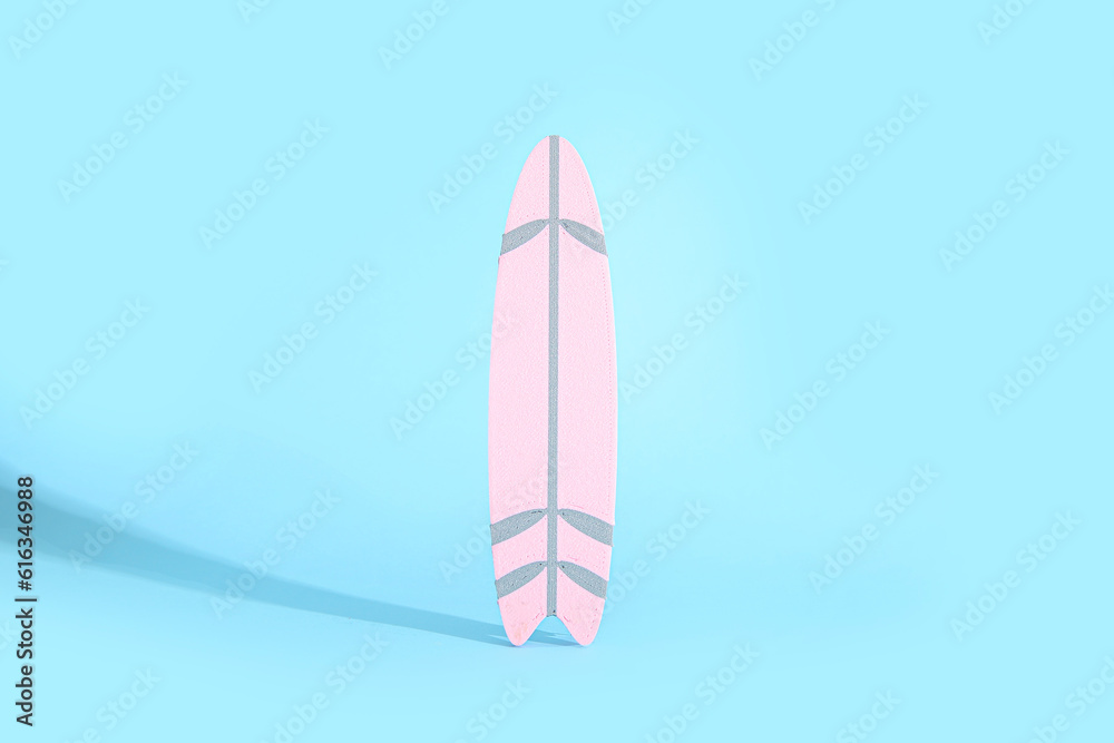 Mini surfboard on blue background