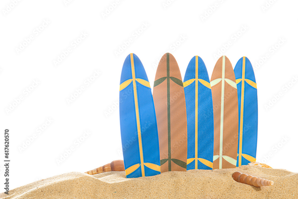 Mini surfboards with seashells on sand against white background
