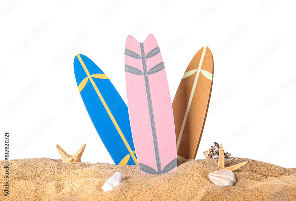 Mini surfboards with seashells and starfishes on sand against white background