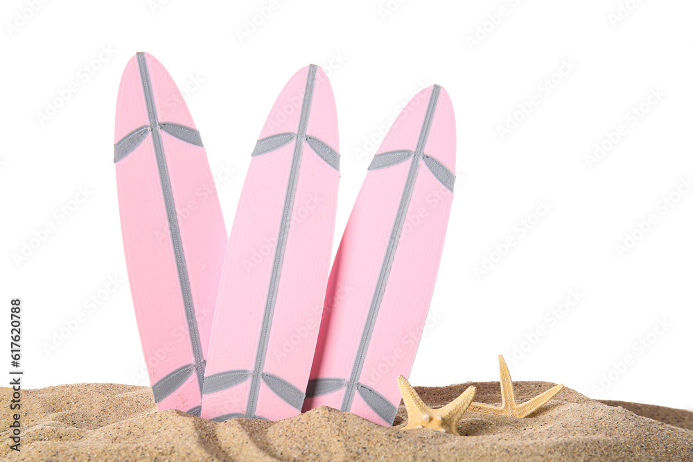 Mini surfboards with starfishes on sand against white background