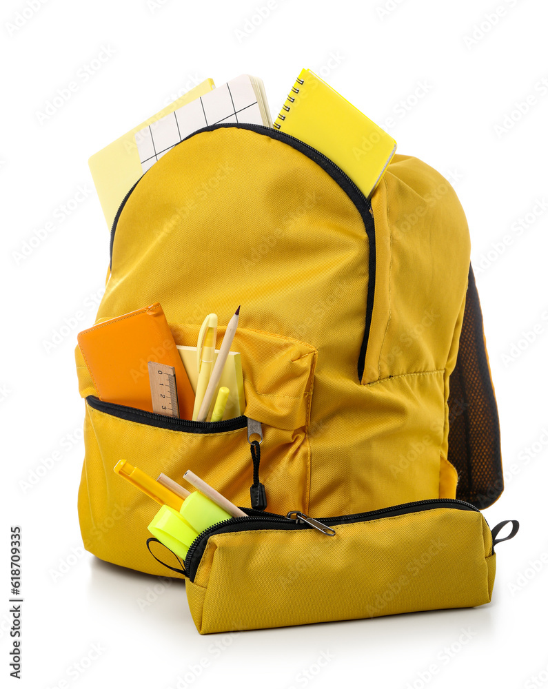 Yellow school backpack with pencil case, notebooks and stationery on white background