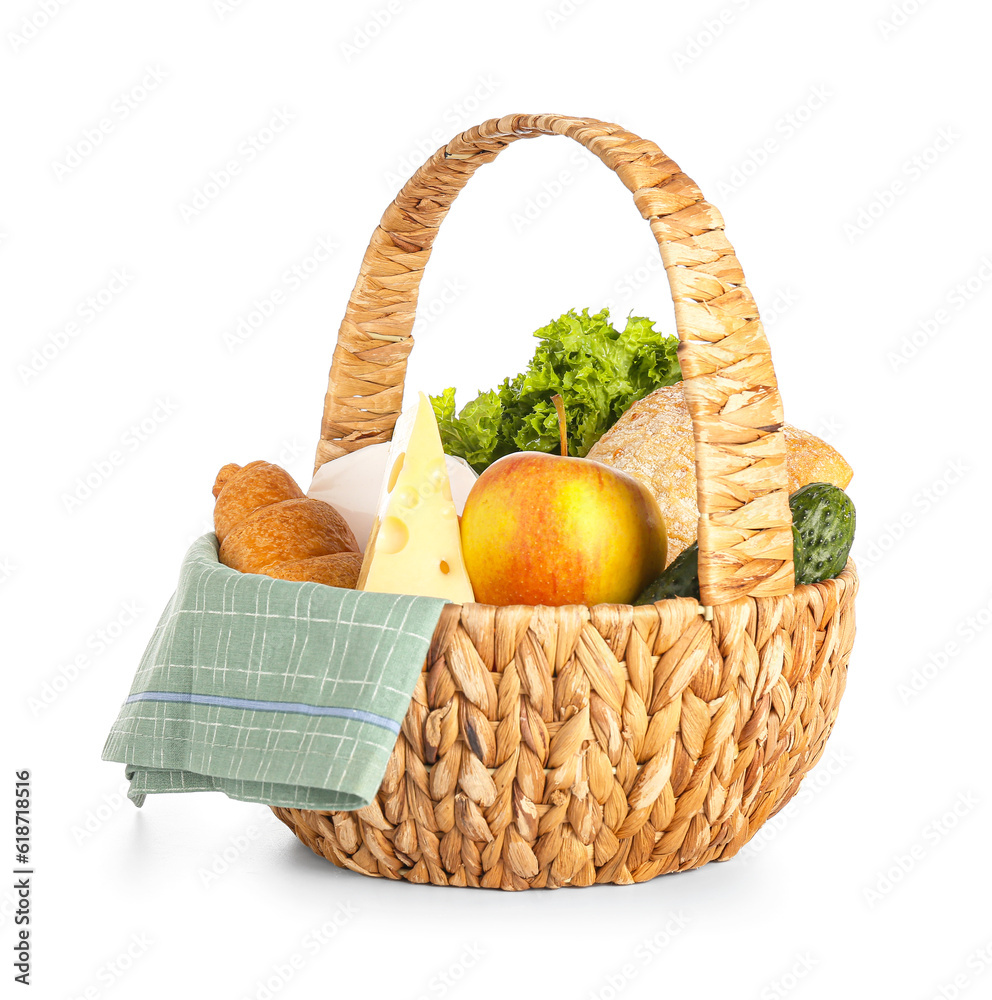 Wicker basket with delicious food for picnic on white background
