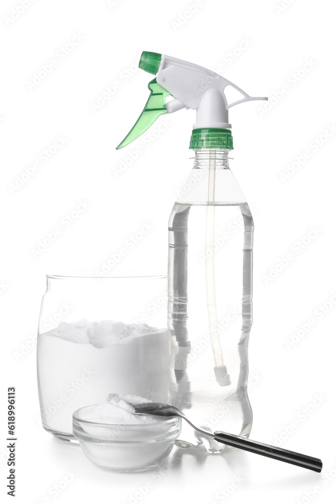Jar of baking soda and sprayer for cleaning on white background
