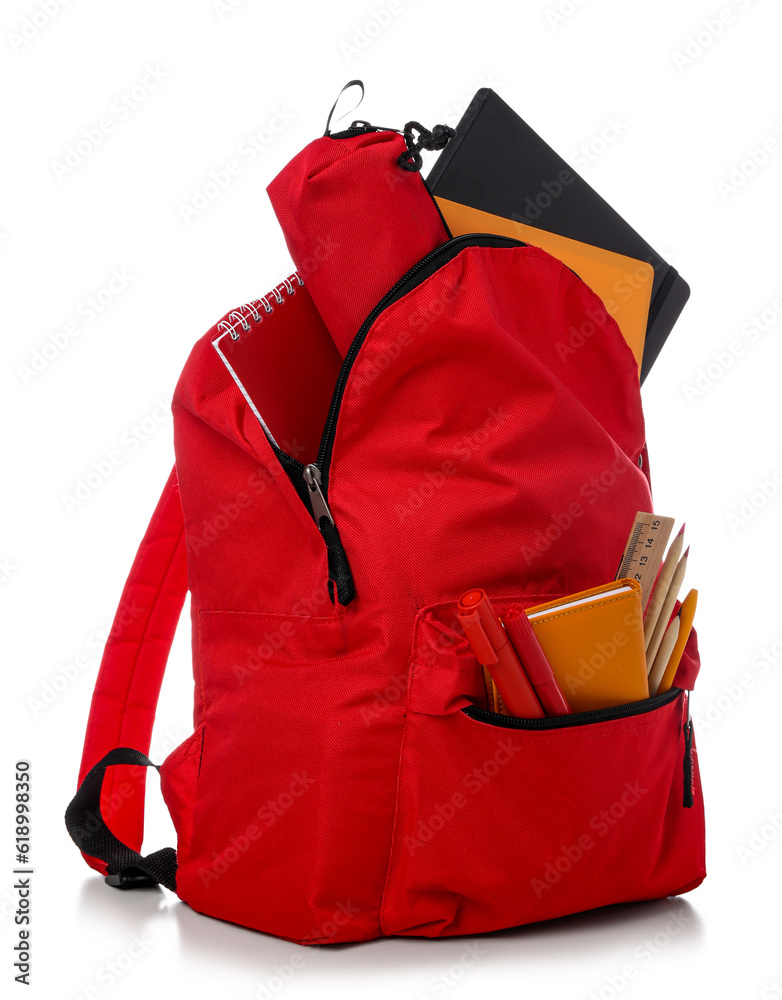 Red school backpack with notebooks, pencil case and markers on white background