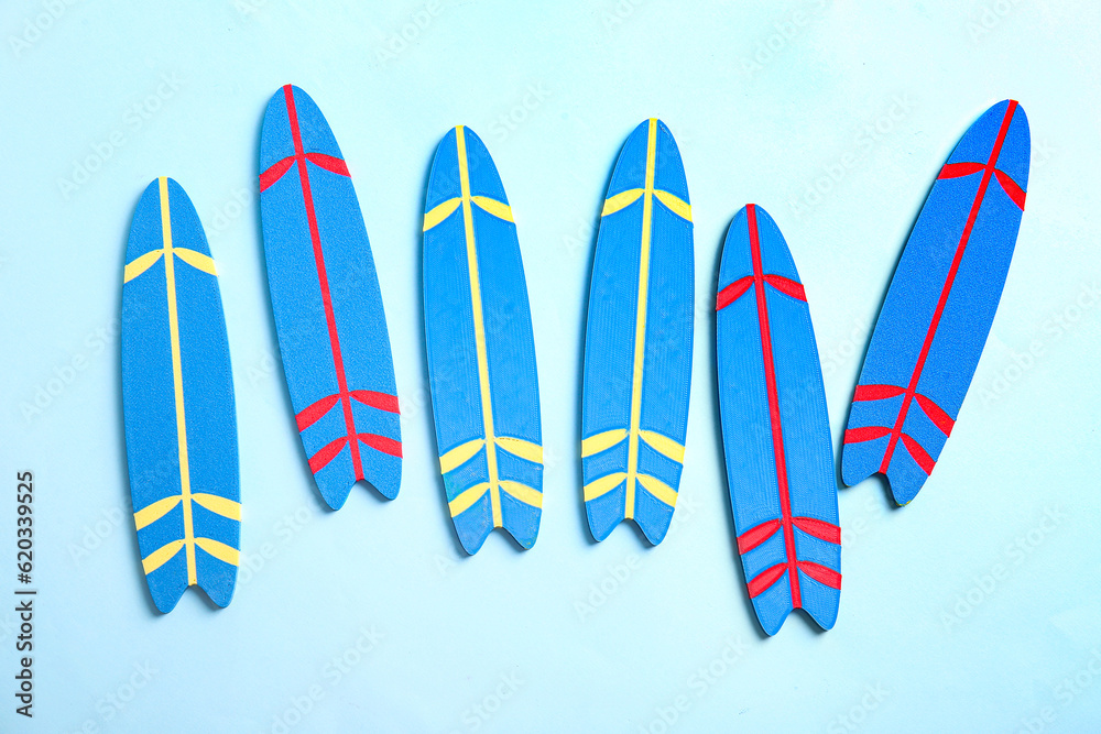 Mini color surfboards on blue background
