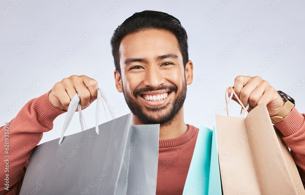Shopping bag, studio portrait and man with happiness, retail product and smile for fashion spree, sa