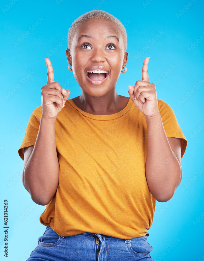 Excited, pointing up and happy black woman with studio advertising space, retail promotion news or a