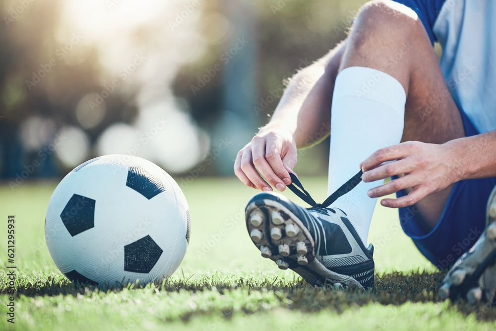 Ball, man and soccer player tie shoes for training, fitness games and performance on field. Closeup,