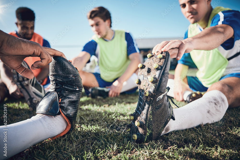 Football player, stretching and feet of men training on a field for sports game and fitness. Closeup