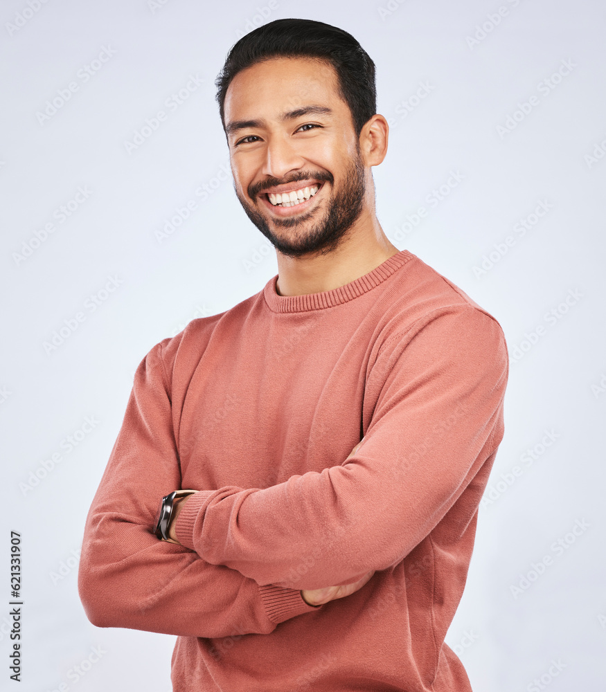 Portrait, smile and Asian man with arms crossed, casual fashion and confident guy against a white st