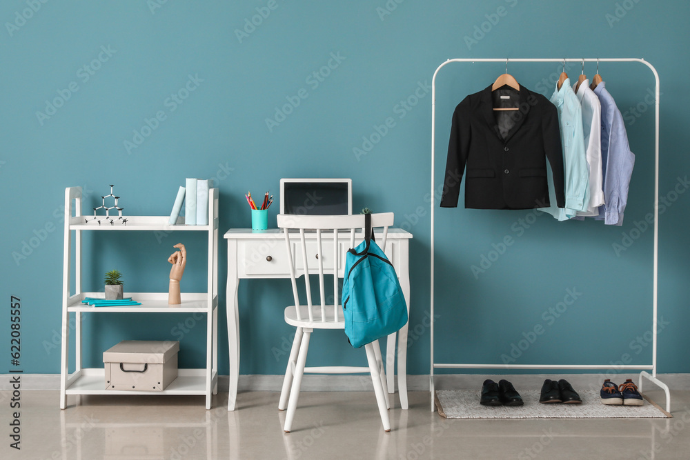 Stylish interior of modern childrens room with school uniform and shoes