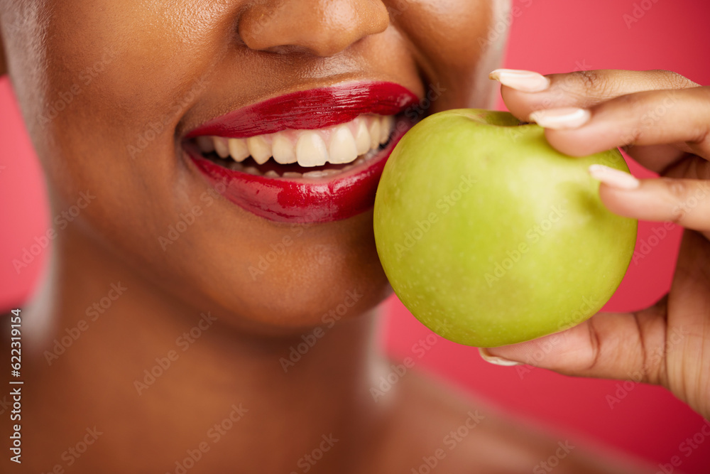 Woman, mouth and apple for natural nutrition, diet or health and wellness against a red studio backg