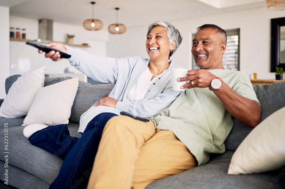 Senior couple, watching tv and relax on sofa in home living room, laughing and together for funny co