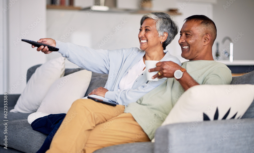 Senior couple, watching tv and relax on couch in home living room, laugh and together for funny come